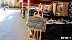People sit at a coffee shop in downtown Beirut, Lebanon, Sept. 28, 2018. 