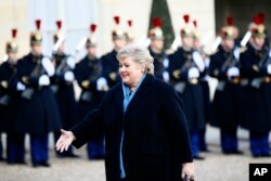 Norway Prime Minister Erna Solberg arrives to be welcomed by French President Emmanuel Macron before a global warming meeting at the Elysee Palace in Paris, Dec. 12, 2017.