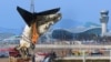 A crane lifts the tail section during the salvage operation of the Jeju Air Boeing 737-800 aircraft which crashed and burst into flames at Muan International Airport, in Muan on January 3, 2025.