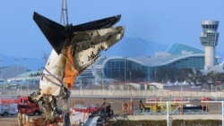 A crane lifts the tail section during the salvage operation of the Jeju Air Boeing 737-800 aircraft which crashed and burst into flames at Muan International Airport, in Muan on January 3, 2025.