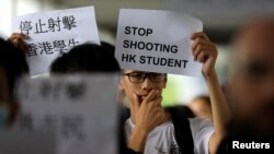 A protester holds a sign following a day of violence over an extradition bill that would allow people to be sent to mainland China for trial, in Hong Kong, June 13, 2019. 