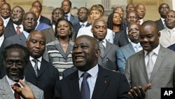 Incumbent President Laurent Gbagbo, center, gestures during a photo opportunity with his newly-named Cabinet, with Prime Minister N'Gbo Gilbert Marie Ake, front left, at the presidency in Abidjan, Ivory Coast, 07 Dec 2010