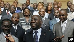Laurent Gbagbo, center, gestures during a photo opportunity with his cabinet on Dec 7, 2010, in Abidjan