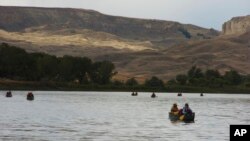 FILE - A group canoes through the Upper Missouri River Breaks National Monument near Fort Benton, Montana, Sept. 19, 2011. The status of many national monument areas has been ordered reviewed by President Donald Trump. 