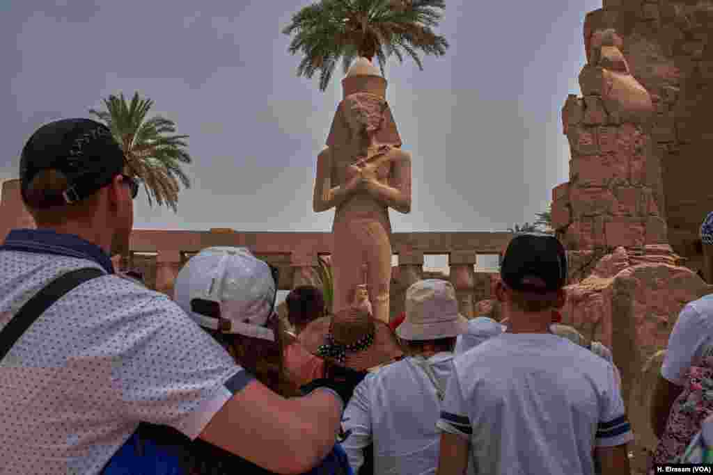 A week after Egypt received the first Russian airline flight after a two-year hiatus, a group of tourists listen to their guide in Karnak temple in Luxor, Egypt, April 20, 2018.