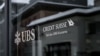 This photograph shows a sign of the Credit Suisse which reads in German as 'part of the UBS group' and displayed on a branch of Swiss banking giant UBS in the resort of St. Moritz on Dec. 20, 2024.