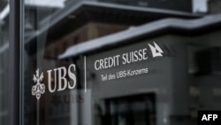 This photograph shows a sign of the Credit Suisse which reads in German as 'part of the UBS group' and displayed on a branch of Swiss banking giant UBS in the resort of St. Moritz on Dec. 20, 2024.