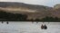 FILE - A group canoes through the Upper Missouri River Breaks National Monument near Fort Benton, Montana, Sept. 19, 2011. The status of many national monument areas has been ordered reviewed by President Donald Trump. 