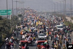 Farmers participate in a protest march towards the capital during India's Republic Day celebrations in New Delhi, India, Jan. 26, 2021.