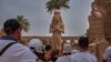 A week after Egypt received the first Russian airline flight after a two-year hiatus, a group of tourists listen to their guide in Karnak temple in Luxor, Egypt, April 20, 2018.