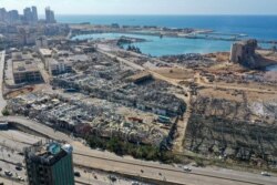 An aerial view shows the massive damage done to Beirut port's grain silos, center, and the area around it on Aug. 5, 2020, one day after a mega-blast tore through the harbor in the heart of the Lebanese capital.