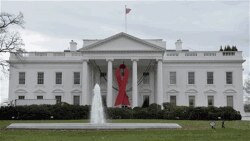 A red ribbon hangs on the White House to mark World AIDS Day.