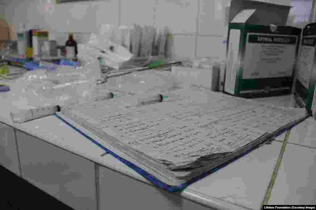 Operating theater log book and drugs in syringes by side of operating theater.