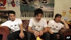 Parents who say their children were killed or made sick by tainted milk powder gather in the apartment of another affected family ahead of a memorial gathering for the victims on the outskirts of Beijing, Sept. 11, 2009.