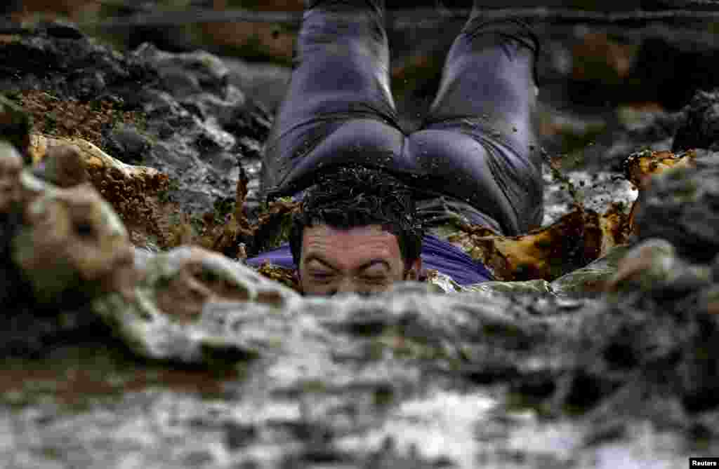 A participant competes in the &quot;Farinato Race&quot; winter extreme run competition in Gijon, northern Spain, Jan. 31, 2016.