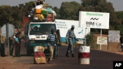 A public transport minibus is stopped by Malian soldiers at a checkpoint at the entrance to Markala, approximately 40 km outside Segou on the road to Diabaly, in central Mali, Jan. 14, 2013.