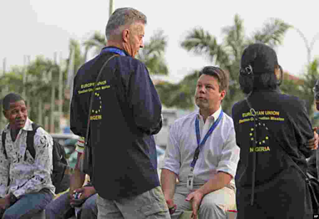 European Union elections observers talk after their arrival ahead of polls in Abuja, March 19, 2011