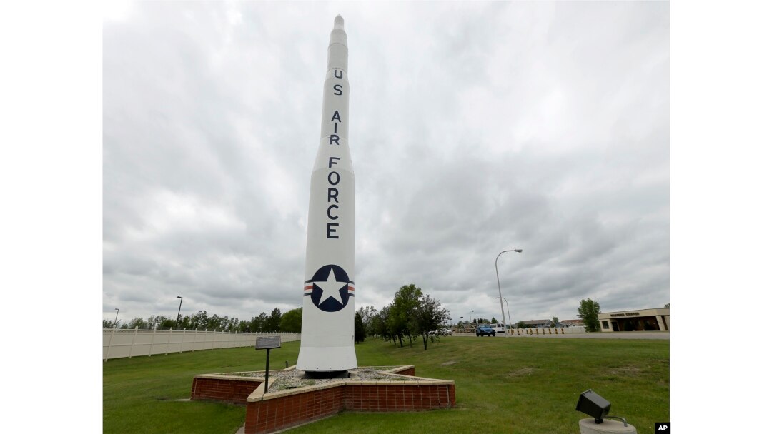 FILE - A retired Minuteman 1 missile stands at the main entrance to Minot Air Force Base, N.D., June 25, 2014. Critics of the intercontinental ballistic missiles have argued that the silos scattered across thousands of square miles of the upper Great Plains are sitting ducks in a war.