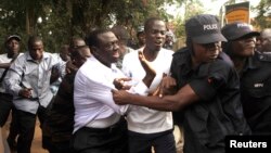 Ugandan police arrested opposition leader Kizza Besigye and supporters before a political rally in July, 2012 in the capital, Kampala.