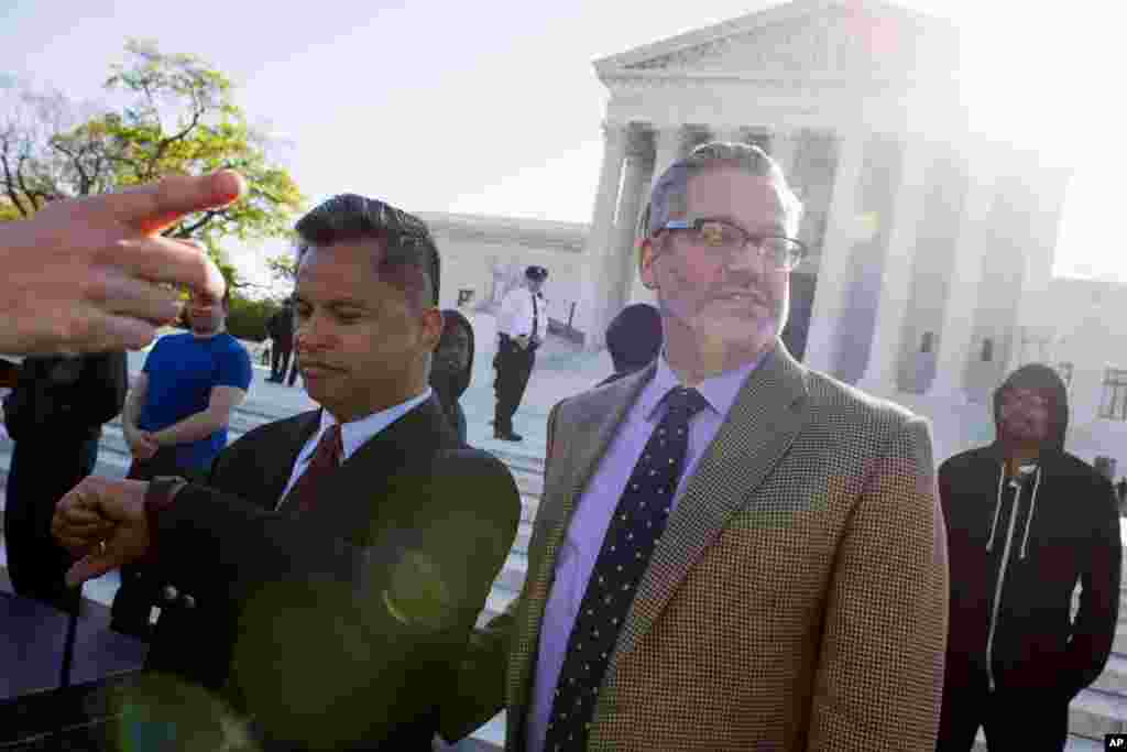 Plaintiffs John Espejo, left, and his husband Matthew Mansell, of Franklin, Tenn., prepare to enter the Supreme Court in Washington, April 28, 2015.
