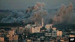 FILE - Smoke rises from explosions caused by Israeli military operations in Gaza City, Jan. 13, 2009. Israel fired white phosphorous shells indiscriminately over densely populated areas of Gaza in what amounts to a war crime, Human Rights Watch said in a report.