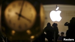 The Apple logo is pictured behind the clock at Grand Central Terminal in the Manhattan borough of New York, Feb. 21, 2016. 