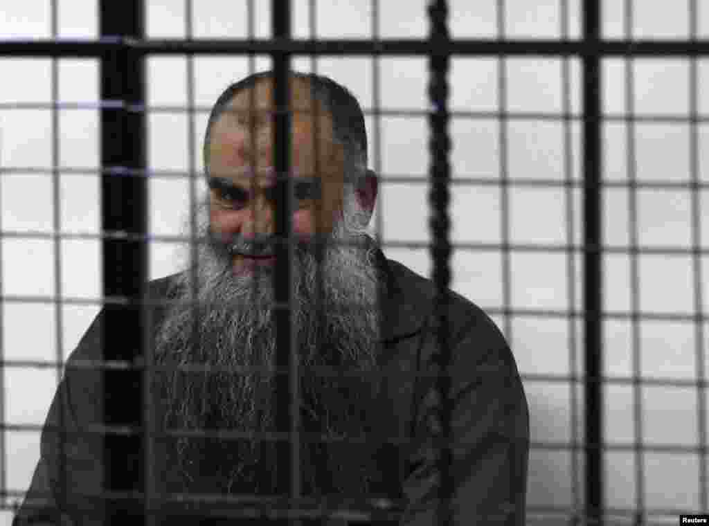 Abu Qatada waits for his verdict at the State Security Court in Amman, Sept. 24, 2014. 