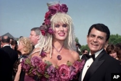 FILE - Casey Kasem, along with his wife, Jean Kasem, arrives at the Emmy Awards in Los Angeles. Kasem, the smooth-voiced radio broadcaster who became the king of the top 40 countdown, died at age 82, June 15, 2014.