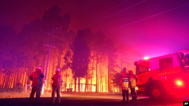 FILE - Firefighters battle a wildfire at Wooroloo, near Perth, Australia, Feb. 1, 2021.