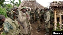 Congolese soldiers gather for a military brief after M23 rebel fighters surrendered in Chanzo village in the Rutshuru territory, near Goma on November 5, 2013. 