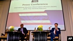Rohana Nishanta Hettiarachchie, left, secretary general of The Asian Network for Free Elections (ANFREL) watches as Amael Vier, program officer for Capacity Building, right, speaks during a press conference concluding their election monitoring in Bangkok