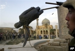 Saddam Hussein's statue is taken down in Baghdad's Firdos Square April 9, 2003, after U.S. and allied troops enter the Iraqi capital.