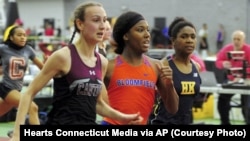 In this Friday, Feb. 14, 2020 photo, Canton High School's Chelsea Mitchell, left, beats Terry Miller, center, of Bloomfield, in the CIAC Class S track and field championships at Floyd Little Athletic Center in New Haven, Conn. center. Between 2017 and 201