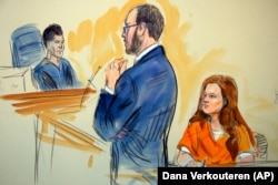 U.S. -- A courtroom sketch depicts Maria Butina, listening to Assistant U.S. Attorney Erik Kenerson as he speaks to Judge Deborah Robinson, left, during a hearing in federal court in Washington, July 18, 2018