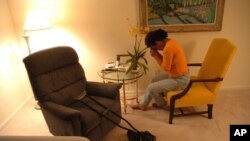 FILE - A patient recovering from hip replacement surgery holds a leaf from an orchid to her face as she practices meditation to deal with her pain.