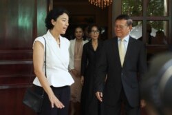 Cambodia National Rescue Party's President Kem Sokha, right, talks with French Ambassador to Cambodia Eva Nguyen Binh, center, at his house in Phnom Penh, Cambodia, Monday, Nov. 11, 2019.