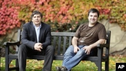 Professor Andre Geim, left, and Dr. Konstantin Novoselov, who have been awarded the Nobel Prize for Physics, pose for pictures outside Manchester University, Manchester, England, 05 Oct 2010