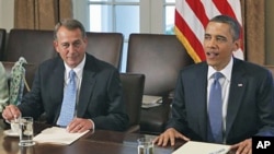 President Barack Obama sits with House Speaker John Boehner of Ohio, as he meets with Republican and Democratic leaders regarding the debt ceiling, in the Cabinet Room of the White House in Washington, DC, July 11, 2011