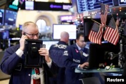 Traders work on the floor of the New York Stock Exchange shortly after the opening bell in New York, Dec. 24, 2018.