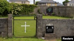 FILE - The entrance to the site of a mass grave of hundreds of children who died in the former Bons Secours home for unmarried mothers is seen in Tuam, County Galway, Ireland, June 4, 2014.