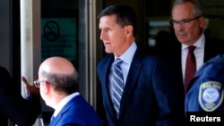 FILE - Former U.S. national security adviser Michael Flynn leaves U.S. District Court, where pleaded guilty of lying to the FBI about his contacts with Russia's ambassador to the United States, in Washington, Dec. 1, 2017.