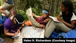 Molly Hancock, left, Yareli Herrera, middle and Taliyah Emory-Muhammad, right, learn how to read a paper map with other girls along the Gore Range Trail near Frisco, Colo. The girls are taking part in a new program called Girls on Rock. (Helen H. Richardson/The Denver Post)