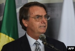 Brazil's President Jair Bolsonaro delivers a speech in Itaipu, Paraguay, Feb. 26, 2019.