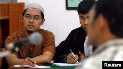 FILE - Bahrun Naim, left, attends his trial at Solo's District Court, Feb. 21, 2011 in this photo taken by Antara Foto. Naim was arrested on suspicion of involvement in a terrorism network in November 2010, and he was convicted in June 2011 of illegal possession of ammunition.