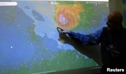 An official of the National Institute of Meteorology shows on a screen the advance of the Hurricane Otto in San Jose, Costa Rica, Nov. 24, 2016.