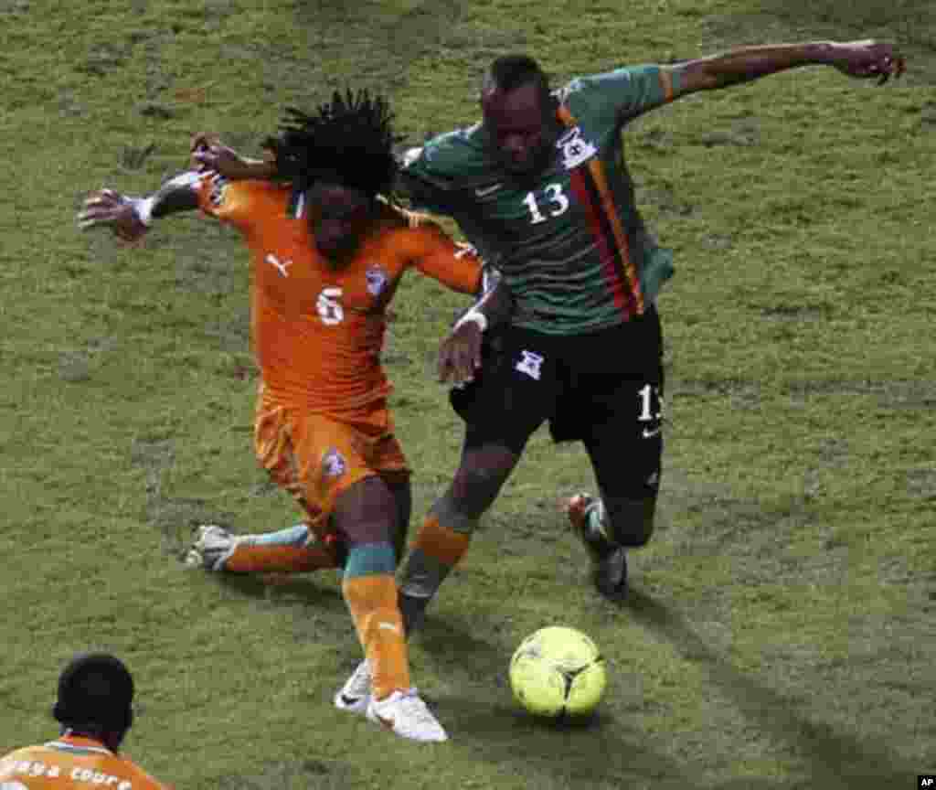 Zambia's Stophira Sunzu (R) is challenged by Ivory Coast's Jean-Jacques Gosso Gosso during their African Nations Cup final soccer match at the Stade De L'Amitie Stadium in Libreville February 12, 2012.
