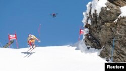 FILE - A TV drone flies beside Canada's Erick Guay during the second practice of the men's Alpine skiing World Cup downhill race at the Lauberhorn in Wengen, January 12, 2012.