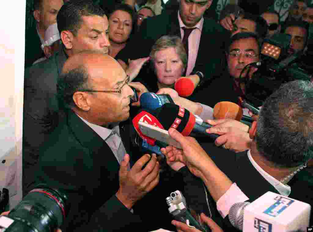 Presidential candidate and Tunisian President Moncef Marzouki addresses the media after he casts his vote during the first round of the Tunisian presidential election, in Sousse, Tunisia, Nov. 23, 2014.