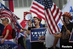 Supporters of U.S. President Donald Trump gather outside Perez Art Museum before his arrival for a town hall in Miami, Florida, U.S., October 15, 2020. REUTERS/Marco Bello