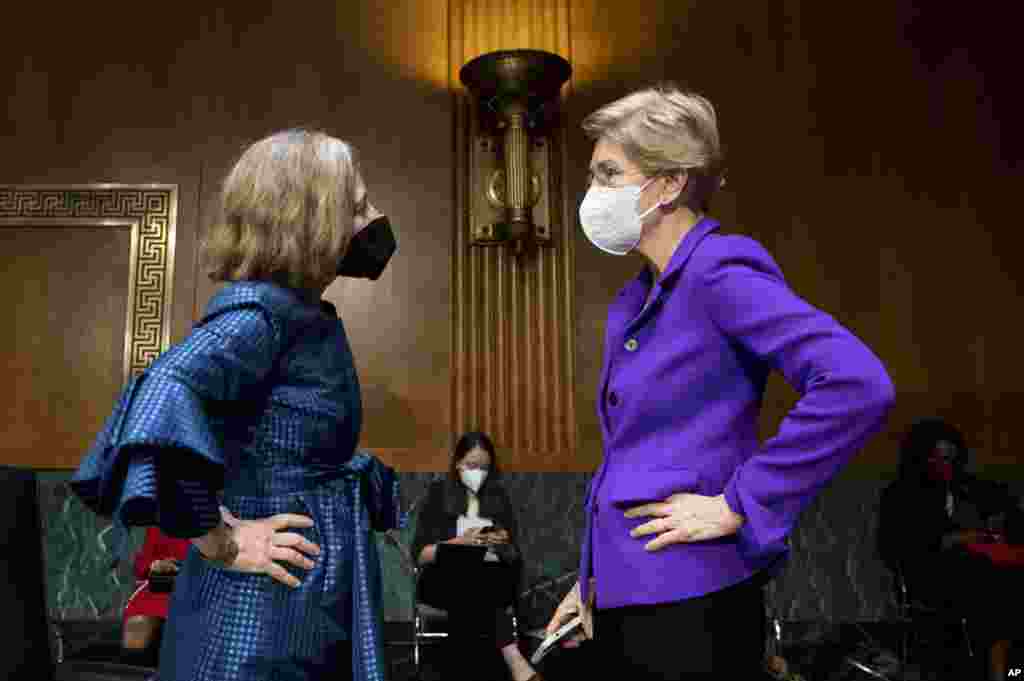 Sen. Elizabeth Warren, D-Mass., right, talks with Sarah Bloom Raskin, a nominee to be the Federal Reserve&#39;s Board of Governors vice chair for supervision, the nation&#39;s top bank regulator, before a Senate Banking, Housing and Urban Affairs Committee confirmation hearing on in Washington.